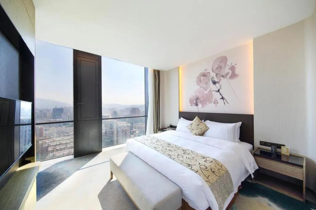 Bed in LONGYAN JINGHUA FLIPORT HOTEL