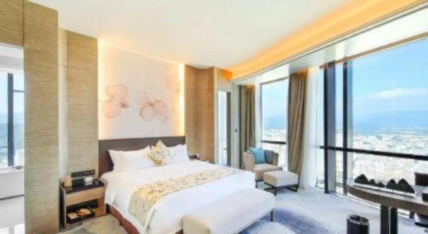 Bed in LONGYAN JINGHUA FLIPORT HOTEL