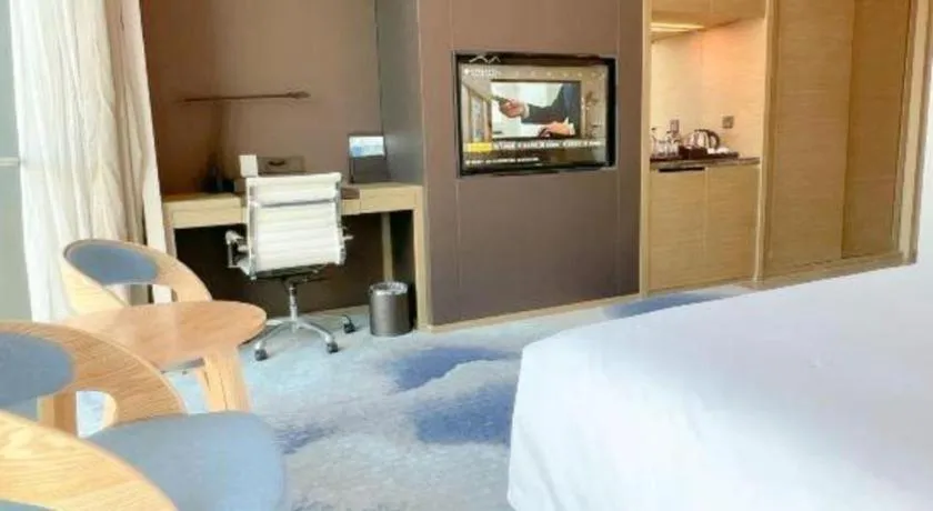 Bed in LONGYAN JINGHUA FLIPORT HOTEL