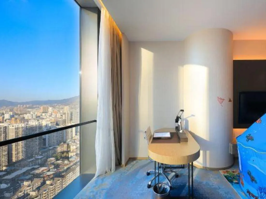 Bed in LONGYAN JINGHUA FLIPORT HOTEL