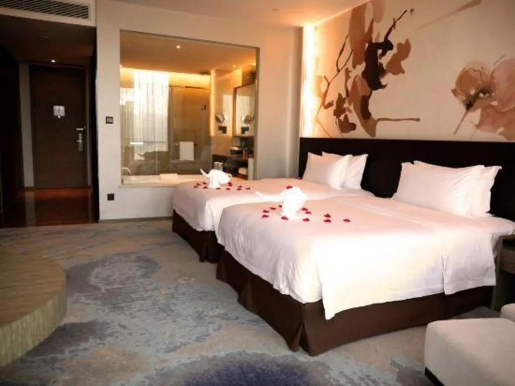 Bed in LONGYAN JINGHUA FLIPORT HOTEL