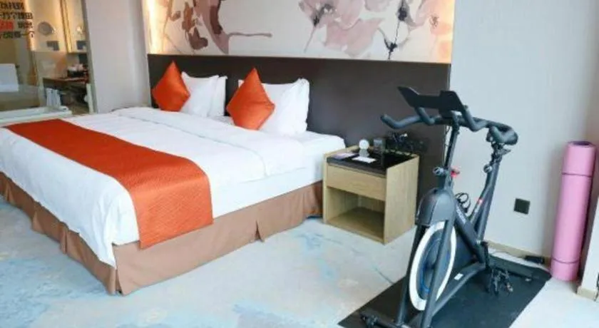 Bed in LONGYAN JINGHUA FLIPORT HOTEL