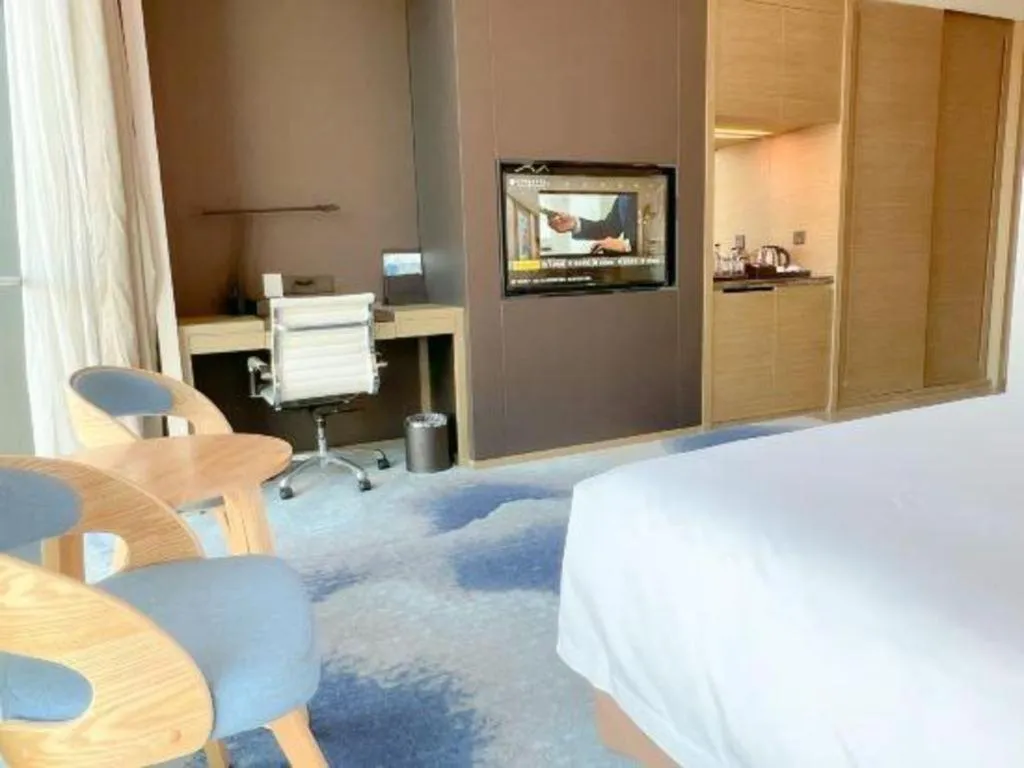 Bed in LONGYAN JINGHUA FLIPORT HOTEL