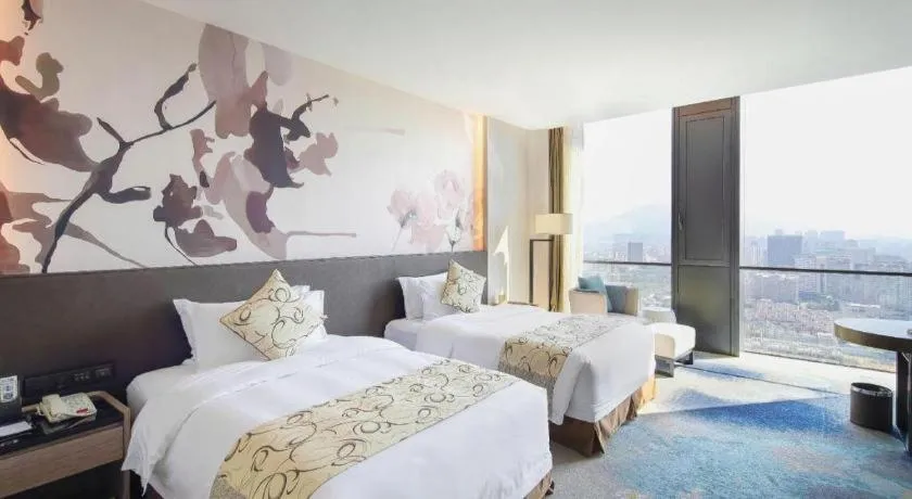 Bed in LONGYAN JINGHUA FLIPORT HOTEL