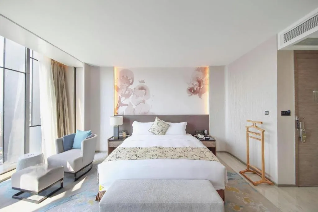 Bed in LONGYAN JINGHUA FLIPORT HOTEL