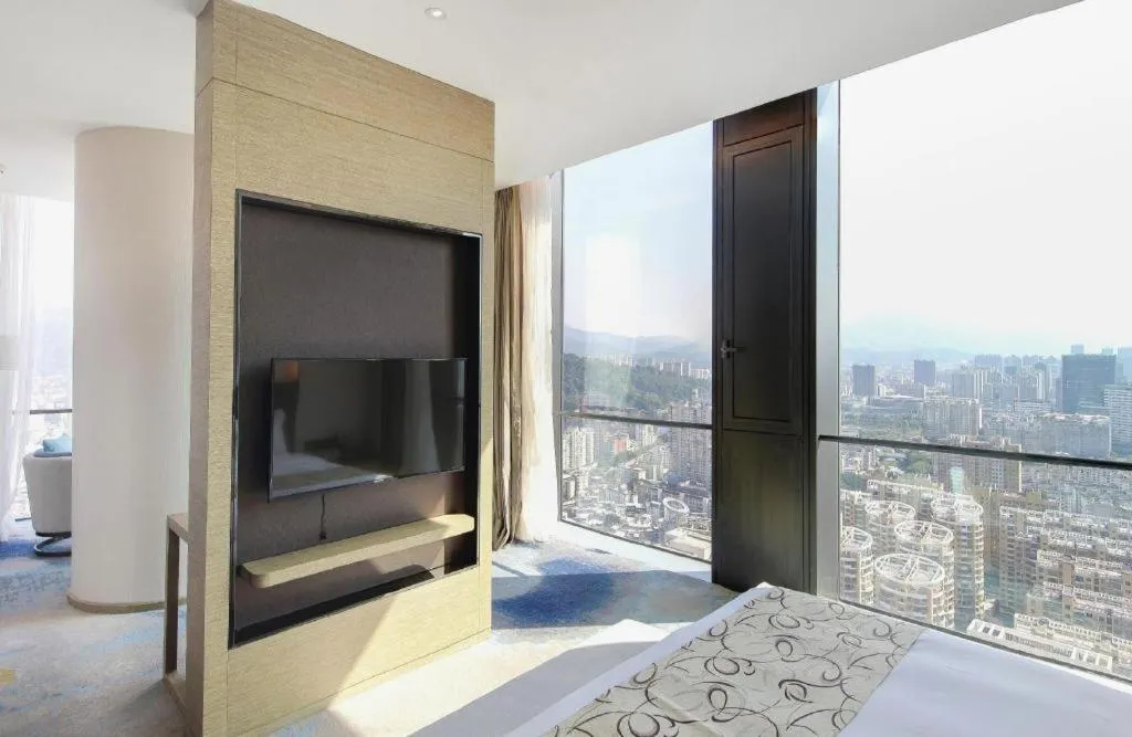 Bed in LONGYAN JINGHUA FLIPORT HOTEL