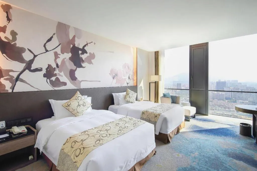 Bed in LONGYAN JINGHUA FLIPORT HOTEL