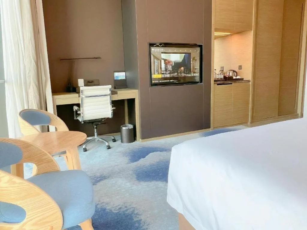 Bed in LONGYAN JINGHUA FLIPORT HOTEL