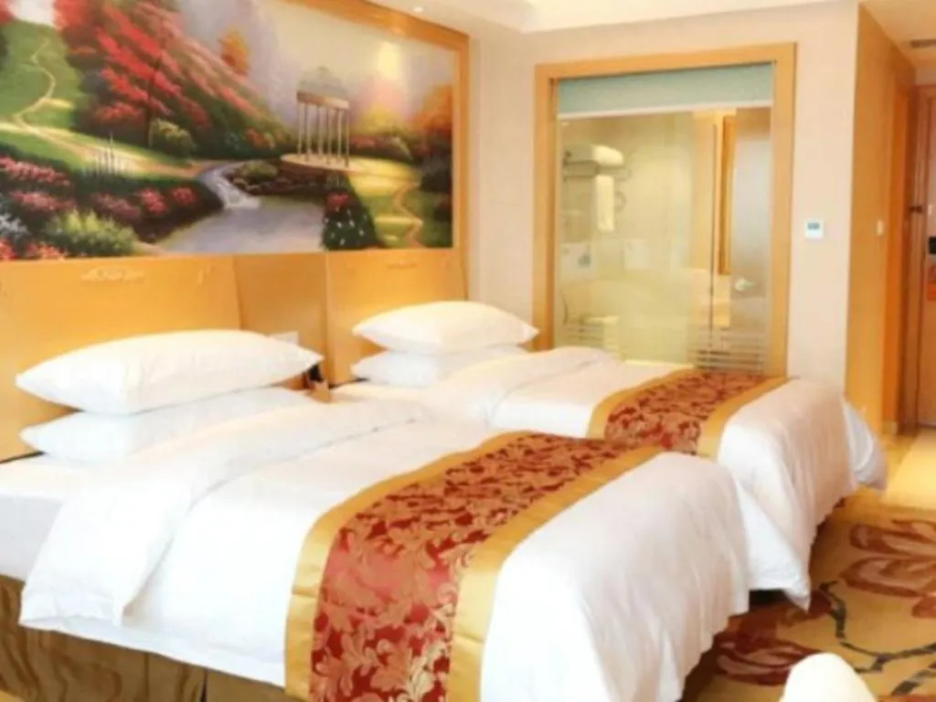 Bed in Vienna Hotel Guangdong Qingyuan Wanda Plaza Xincheng Beijiang