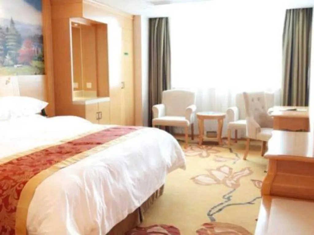 Bed in Vienna Hotel Guangdong Qingyuan Wanda Plaza Xincheng Beijiang