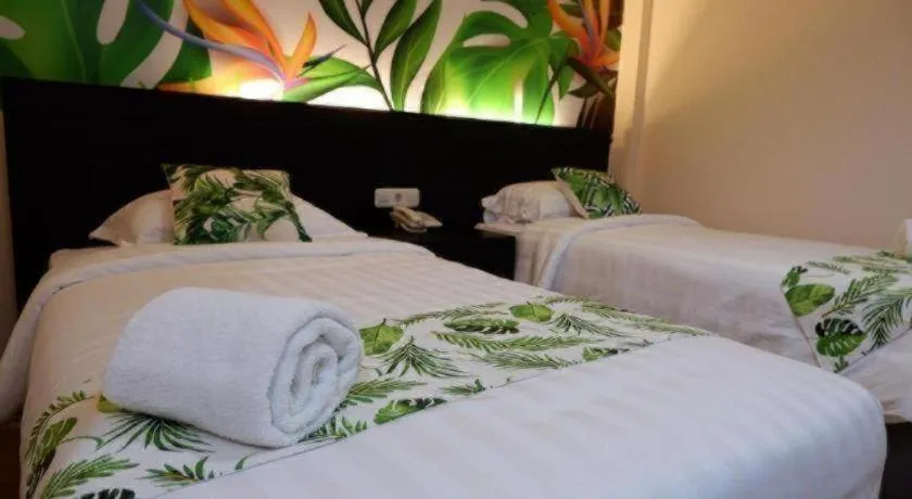 Bed in Tropical Point Hotel Syariah