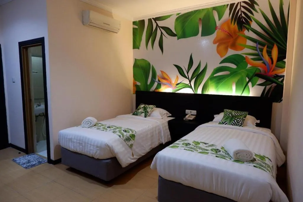 Bed in Tropical Point Hotel Syariah