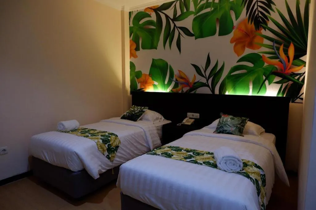 Bed in Tropical Point Hotel Syariah