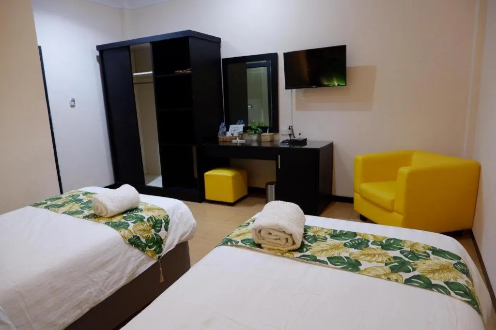 Bed in Tropical Point Hotel Syariah