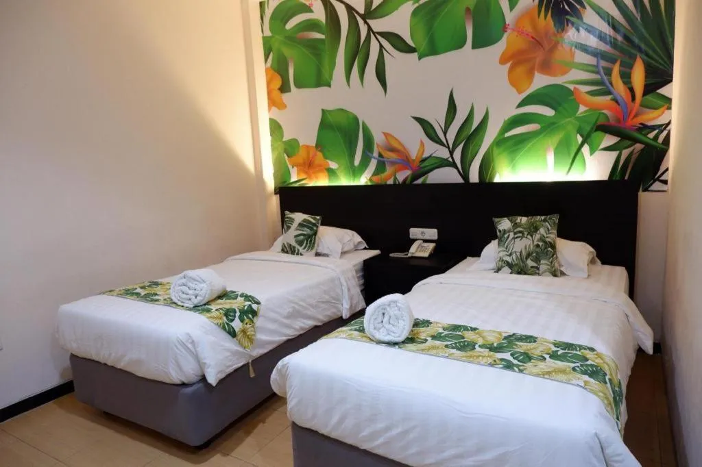 Bed in Tropical Point Hotel Syariah