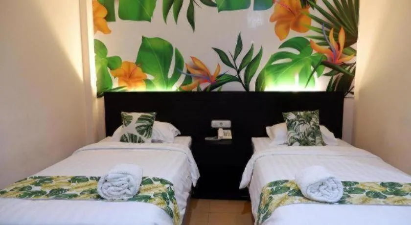 Bed in Tropical Point Hotel Syariah