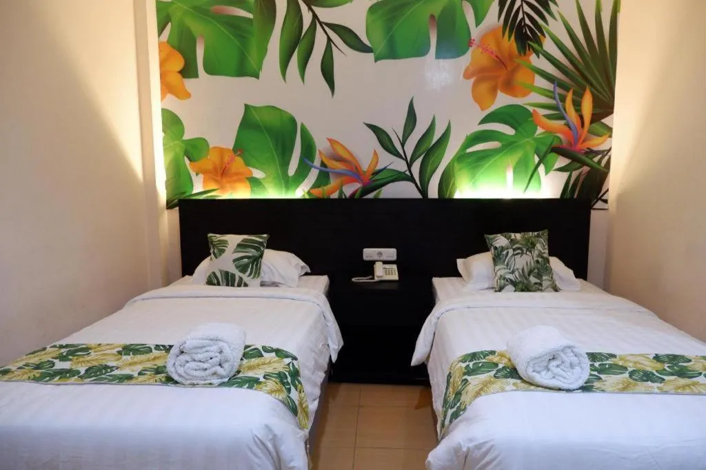 Bed in Tropical Point Hotel Syariah