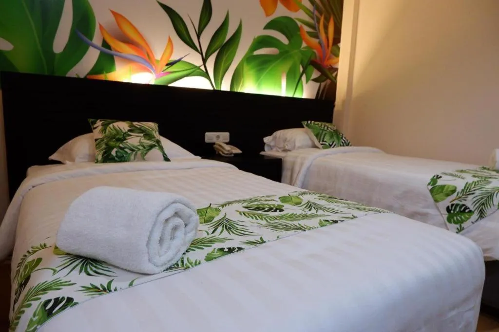 Bed in Tropical Point Hotel Syariah