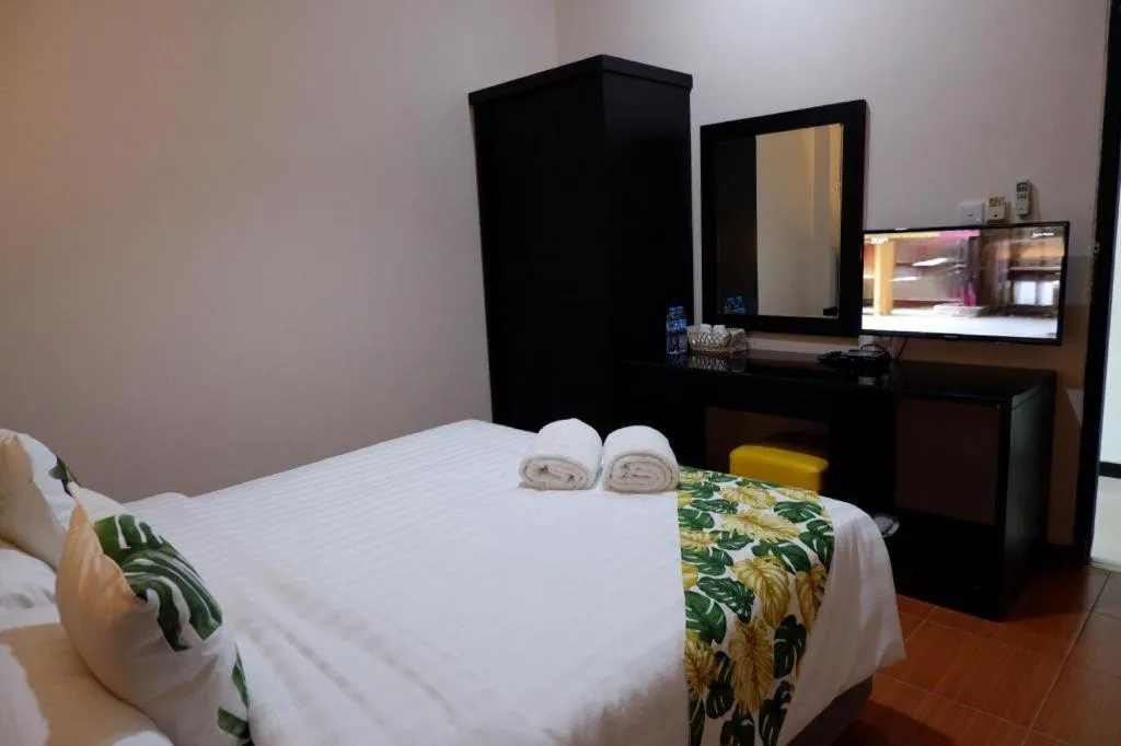 Bed in Tropical Point Hotel Syariah