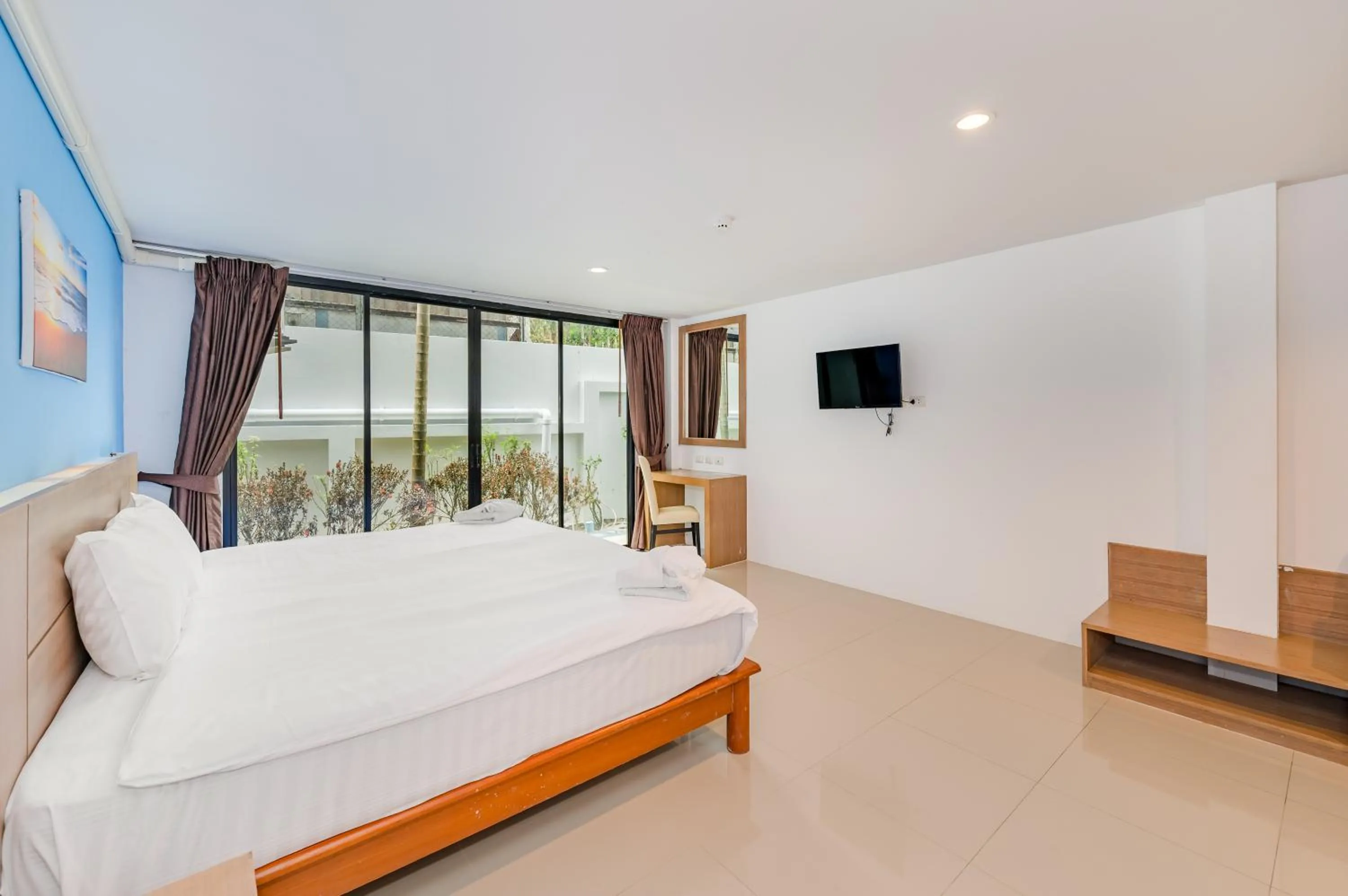 Bed in De Blue Sea Rawai Hotel