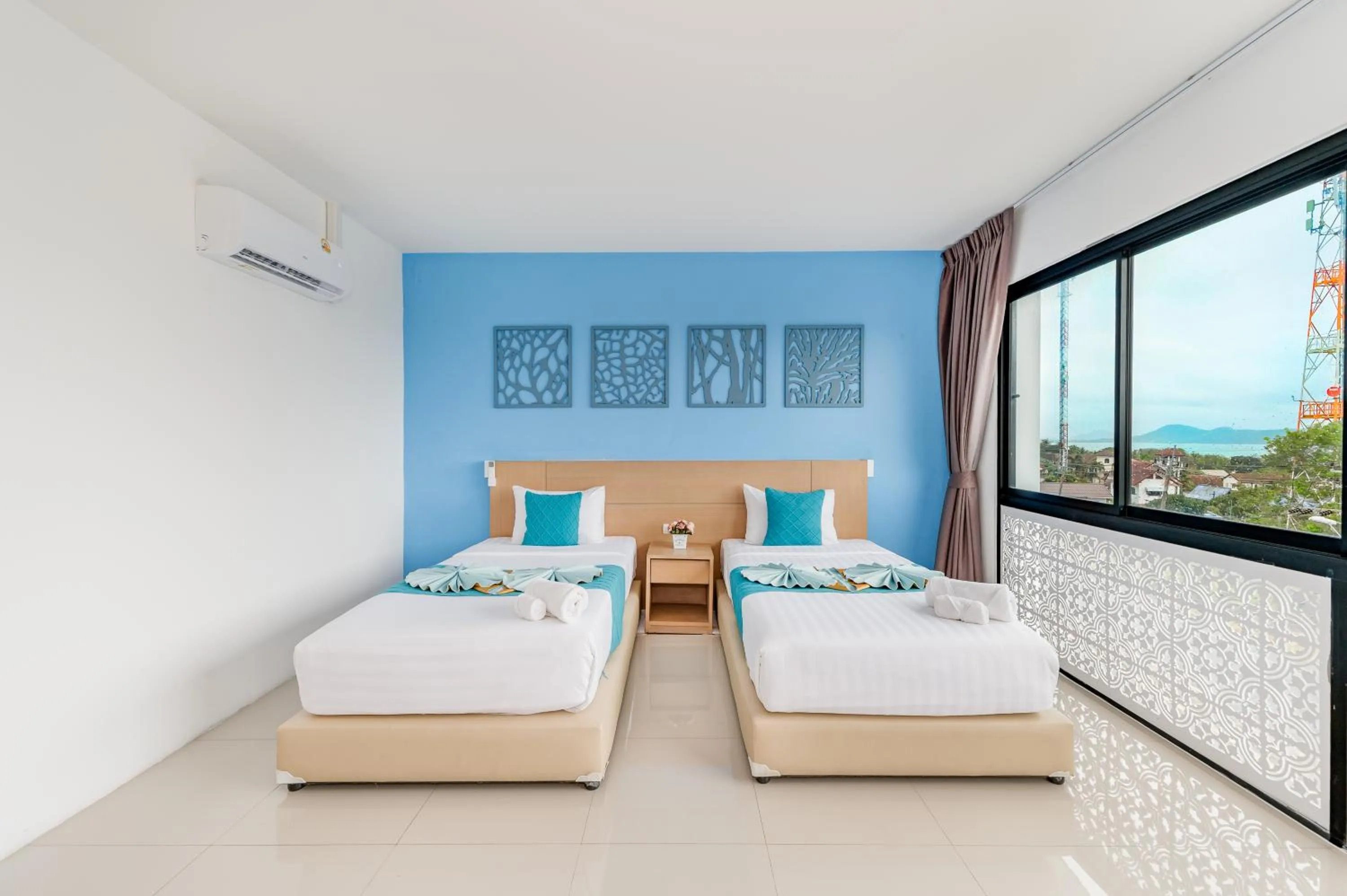 Bed in De Blue Sea Rawai Hotel
