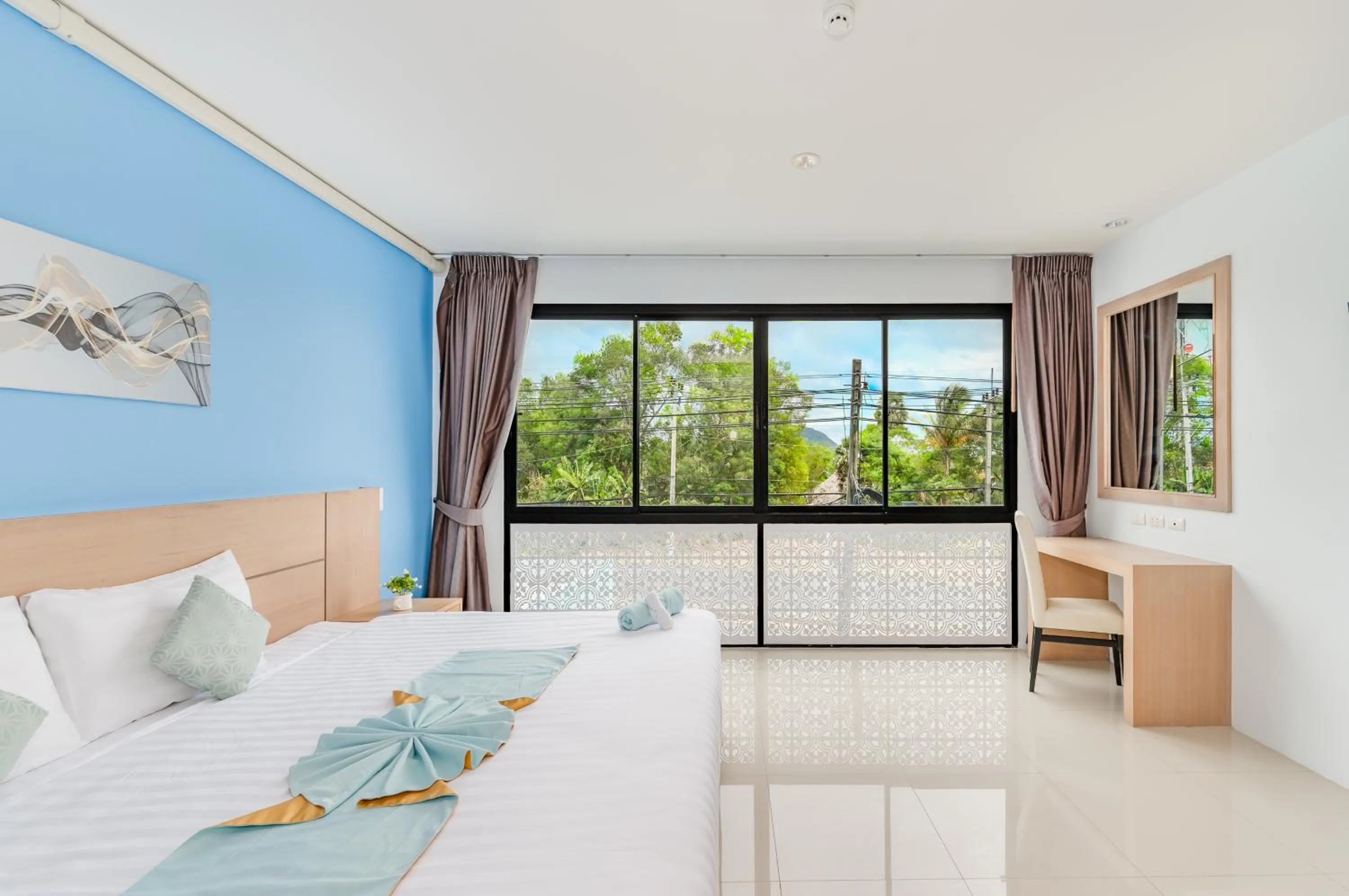 Bed in De Blue Sea Rawai Hotel