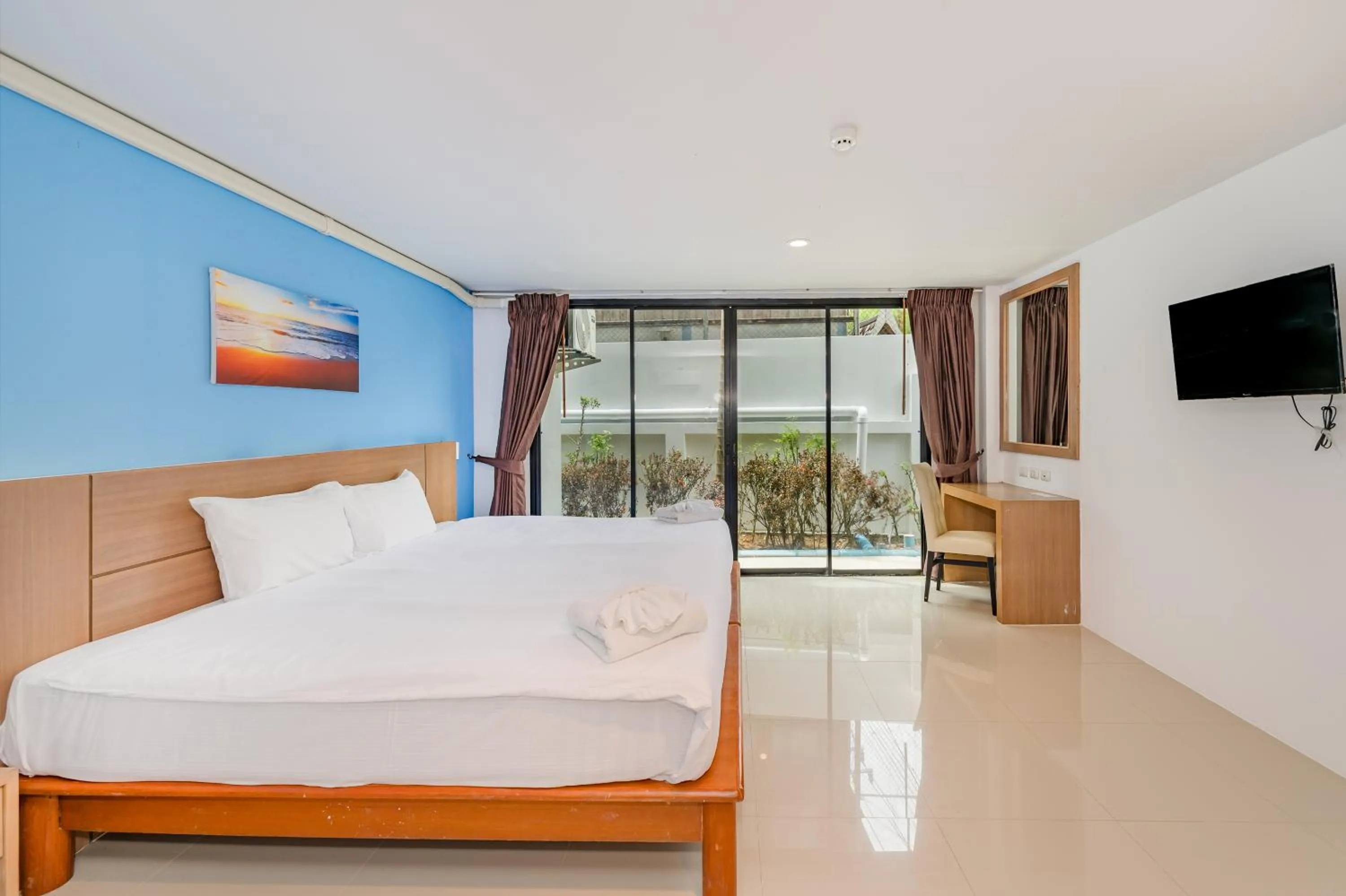 Bed in De Blue Sea Rawai Hotel