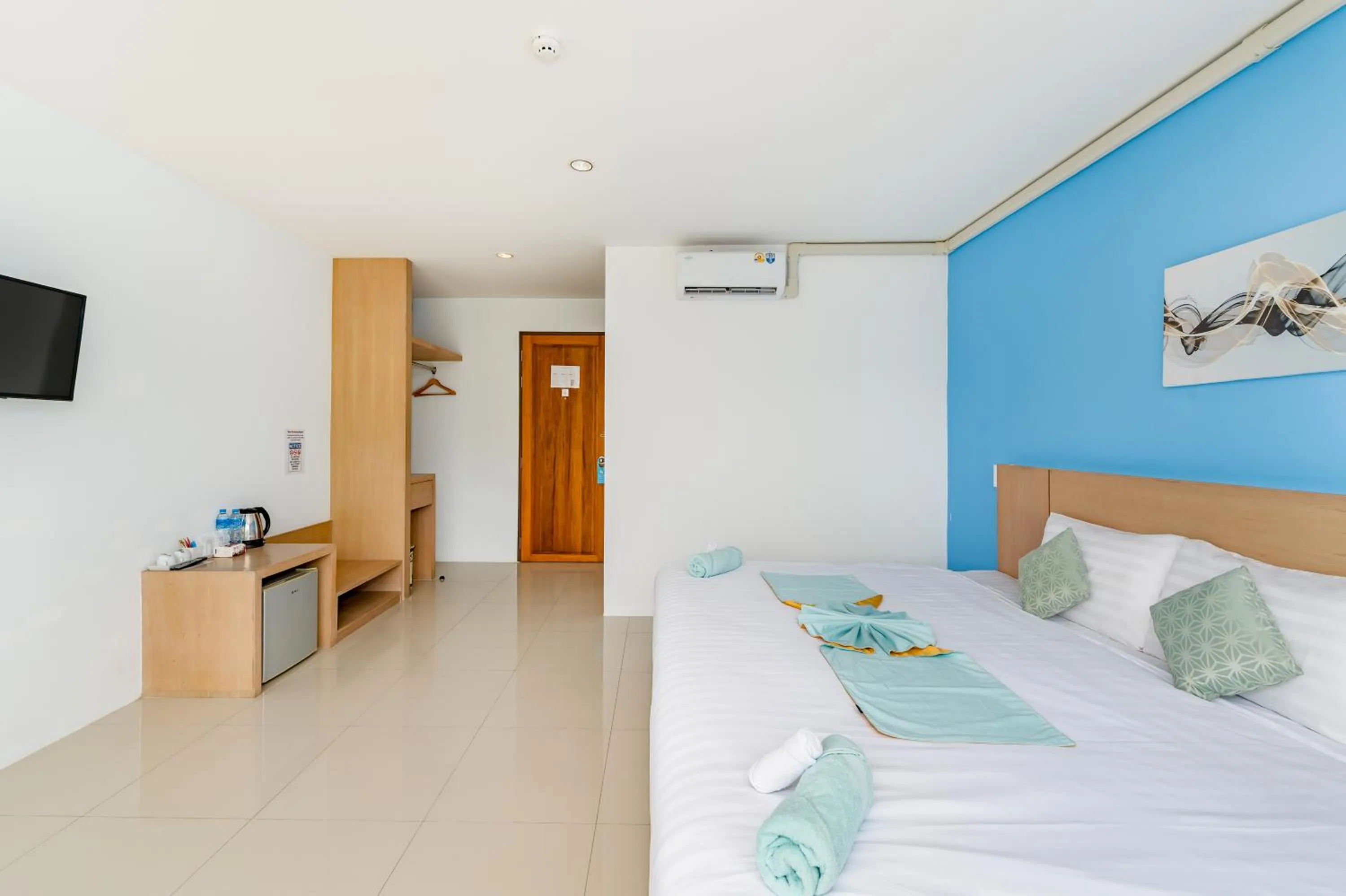 Bed in De Blue Sea Rawai Hotel