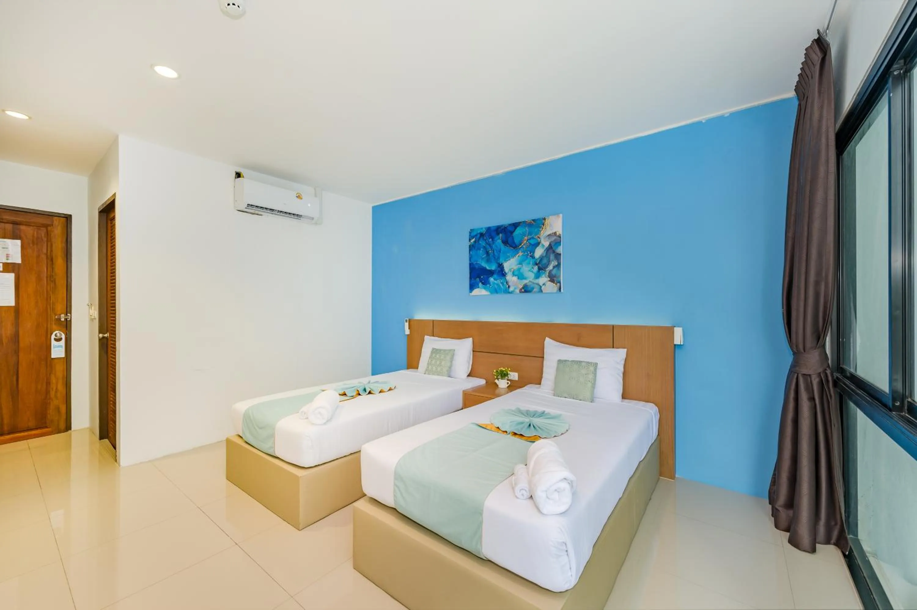Bed in De Blue Sea Rawai Hotel