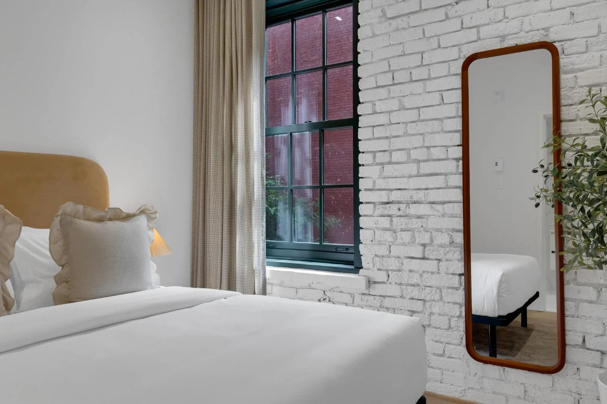 Bed in The Mercer Boutique Hotel