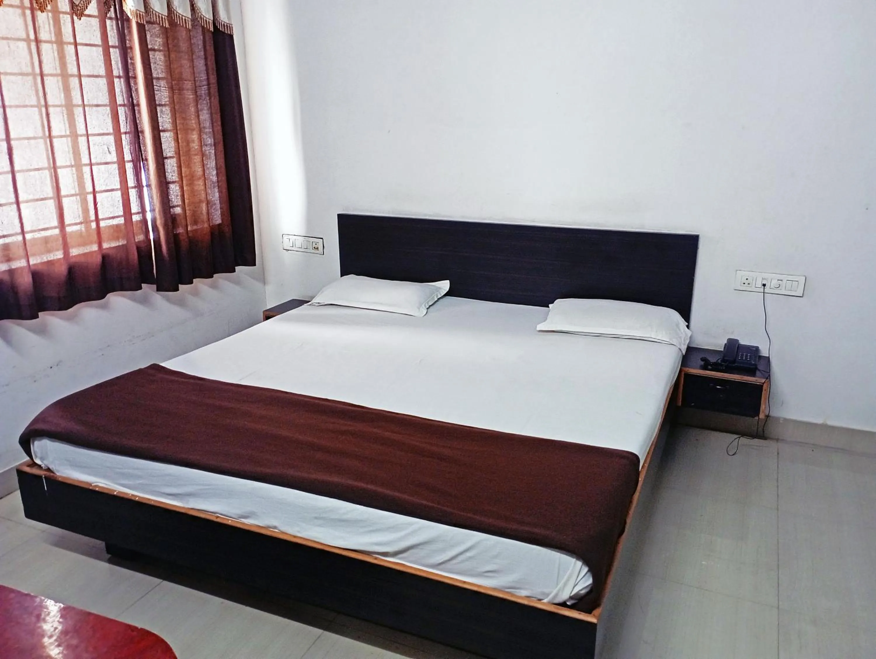 Bedroom in Savanur Deluxe Lodge