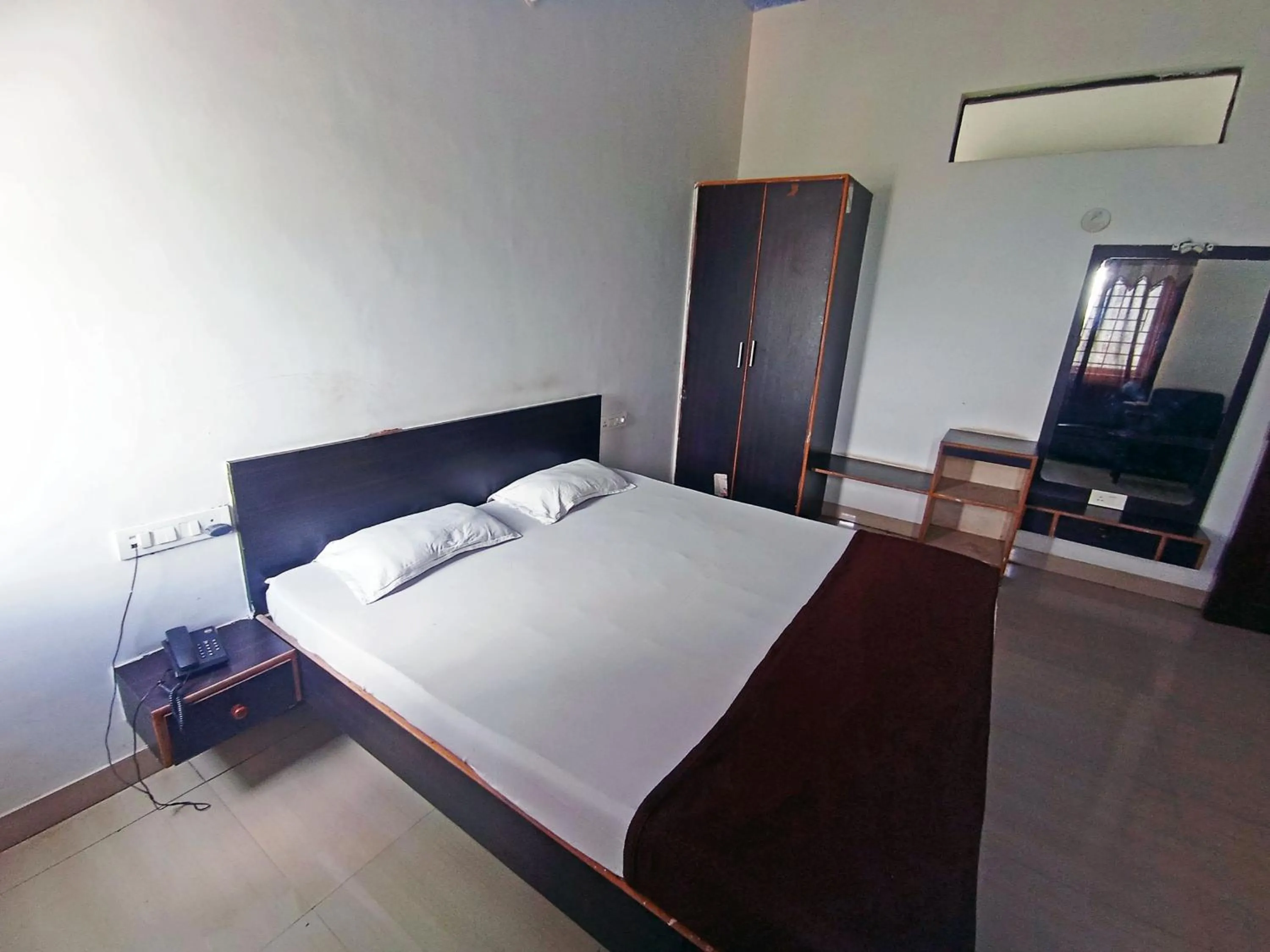 Bedroom in Savanur Deluxe Lodge