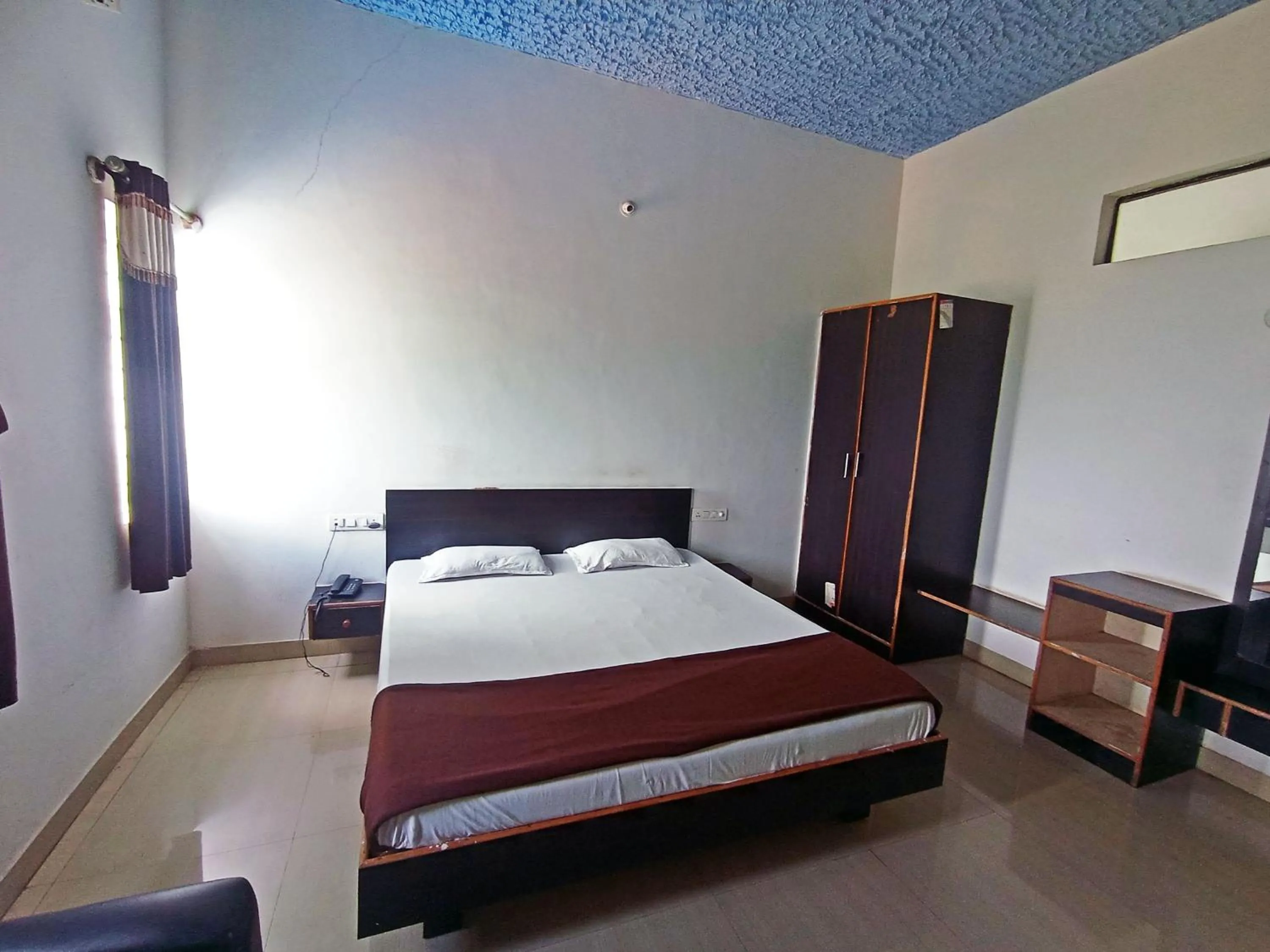 Bedroom in Savanur Deluxe Lodge