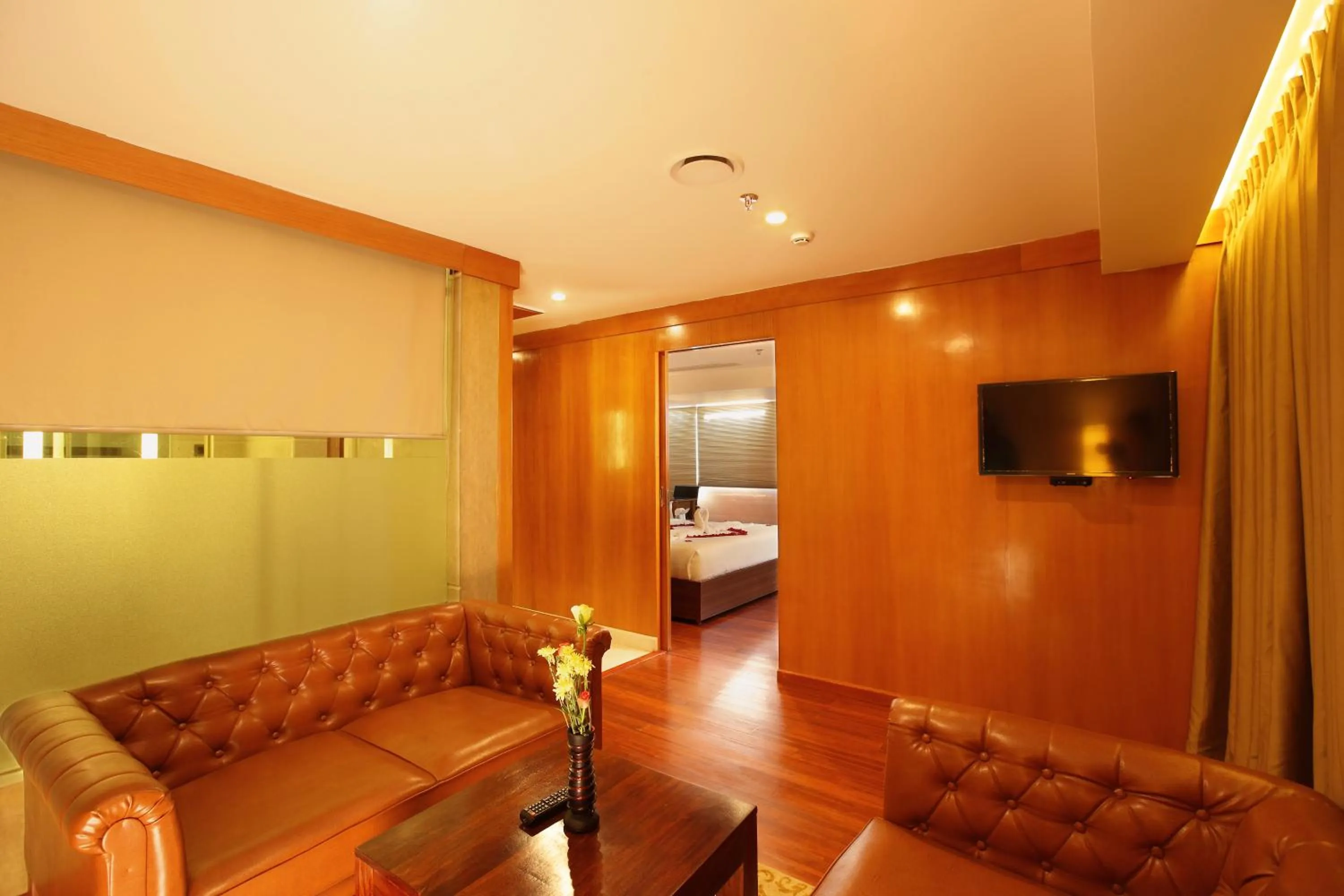 Communal lounge/ TV room, Bed in The Garuda Hotels