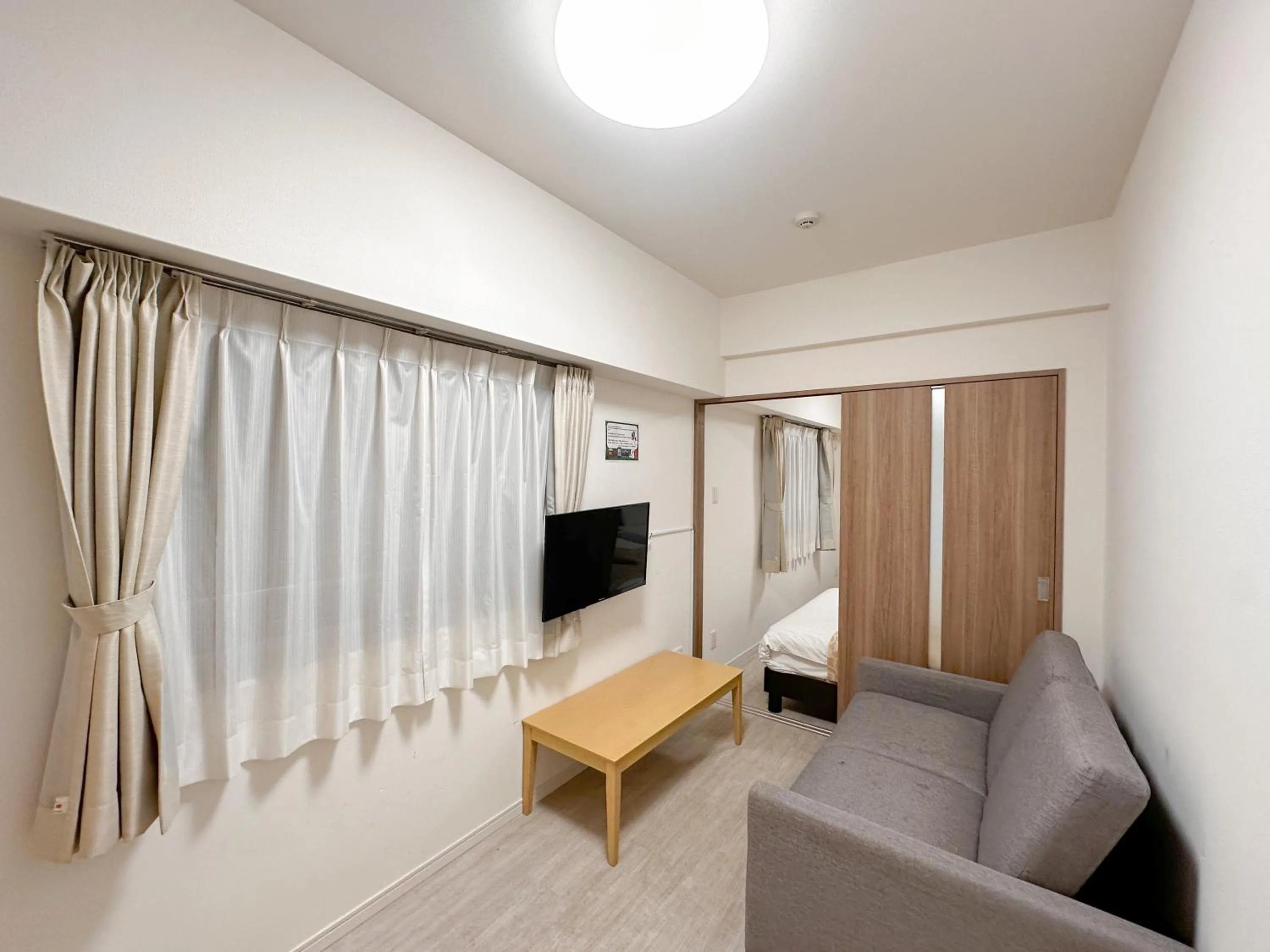 Living room, Bed in Legatio HAKATA Station East