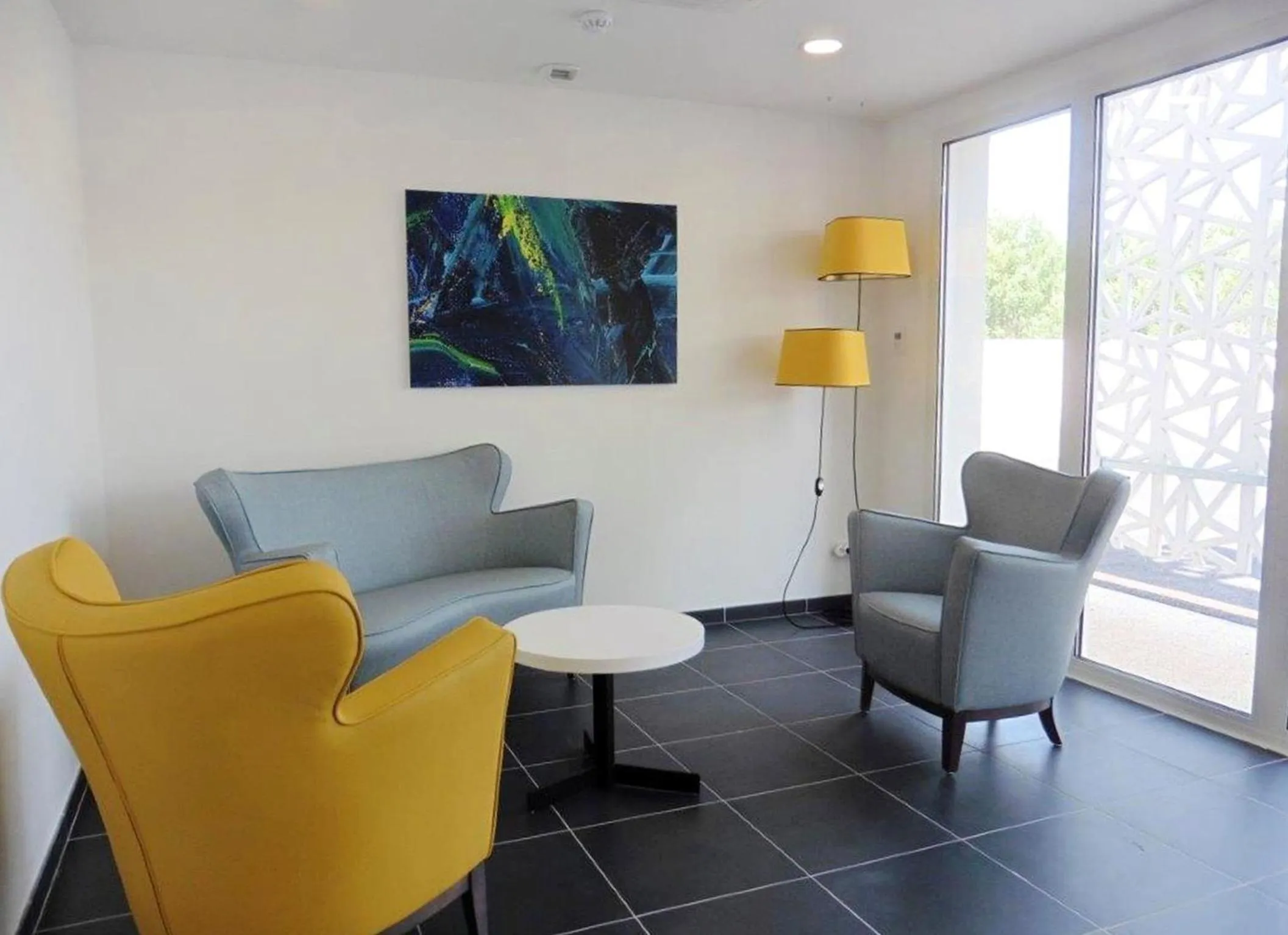 Communal lounge/ TV room in Appart'Hotel Nakâra by Odalys