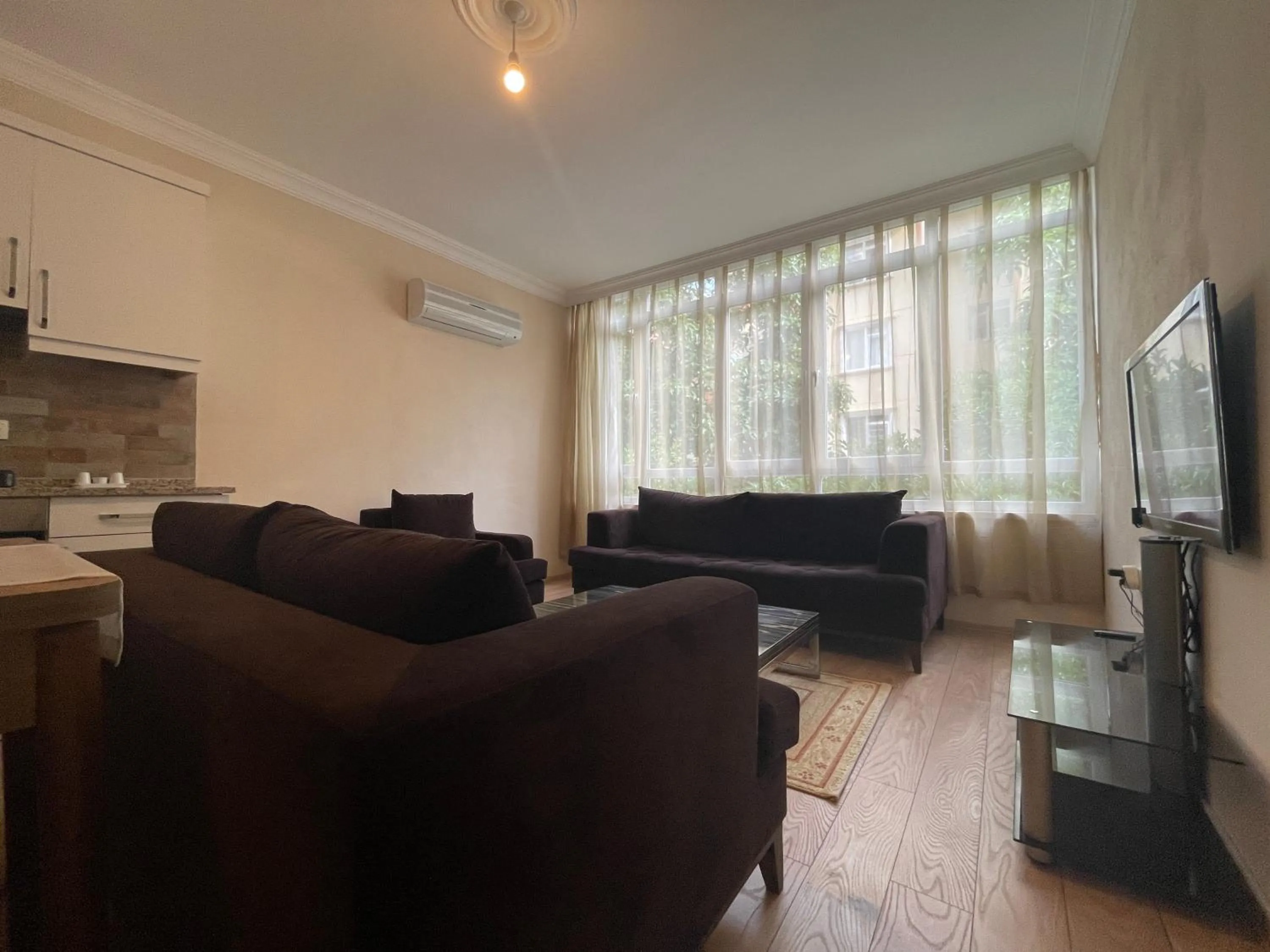 Communal lounge/ TV room in Select Suite & Apart Hotel