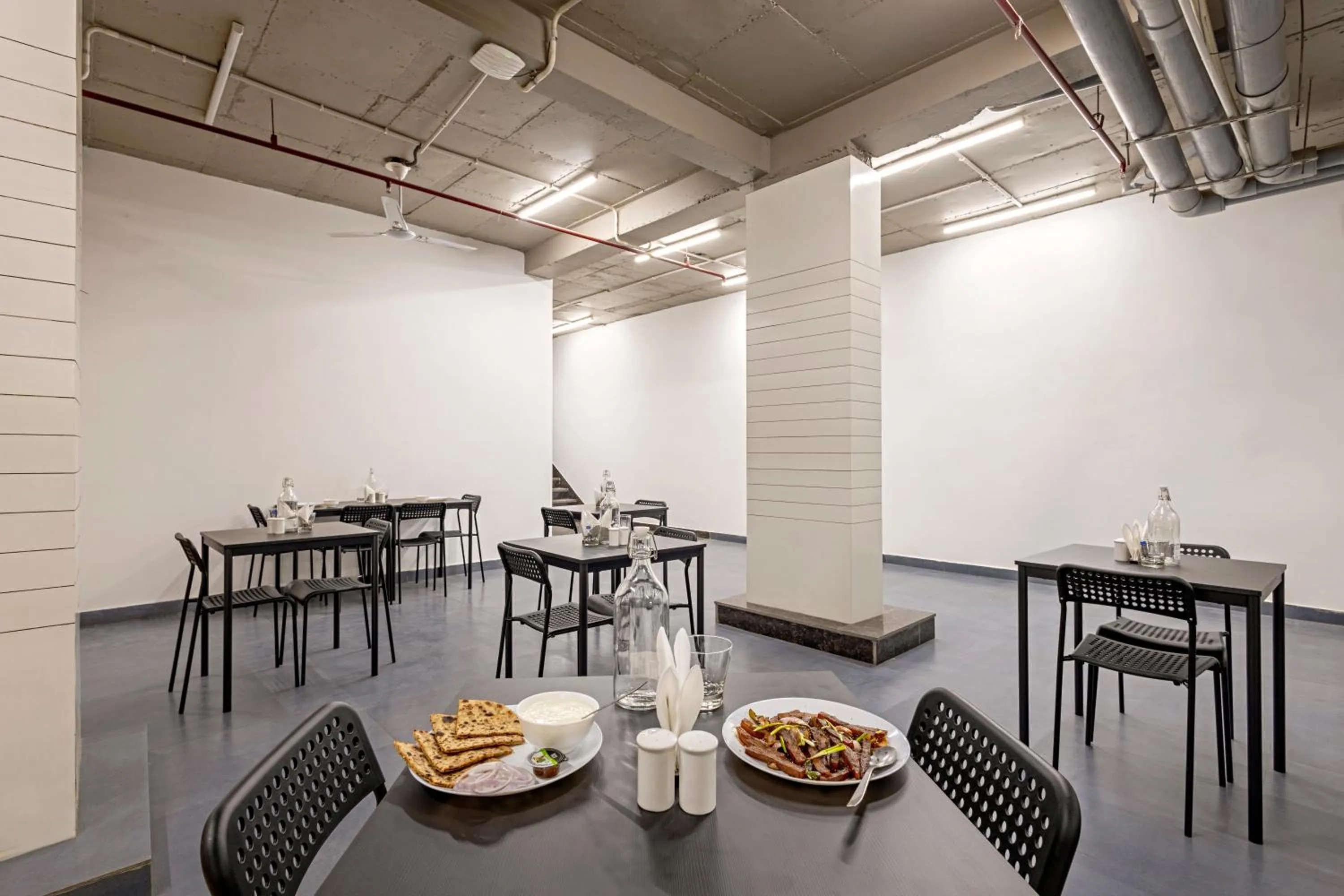 Dining area in Wandr Hotel Medicity Gurugram, Near Medanta Hospital