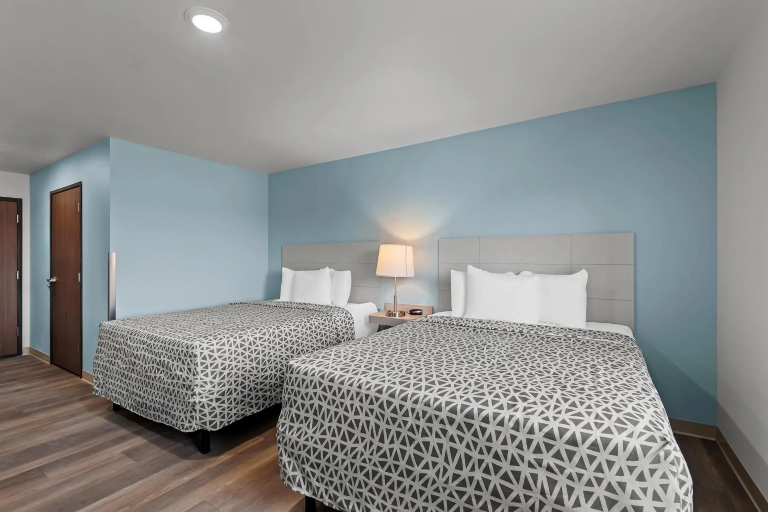 Bed in WoodSpring Suites Coralville Iowa City