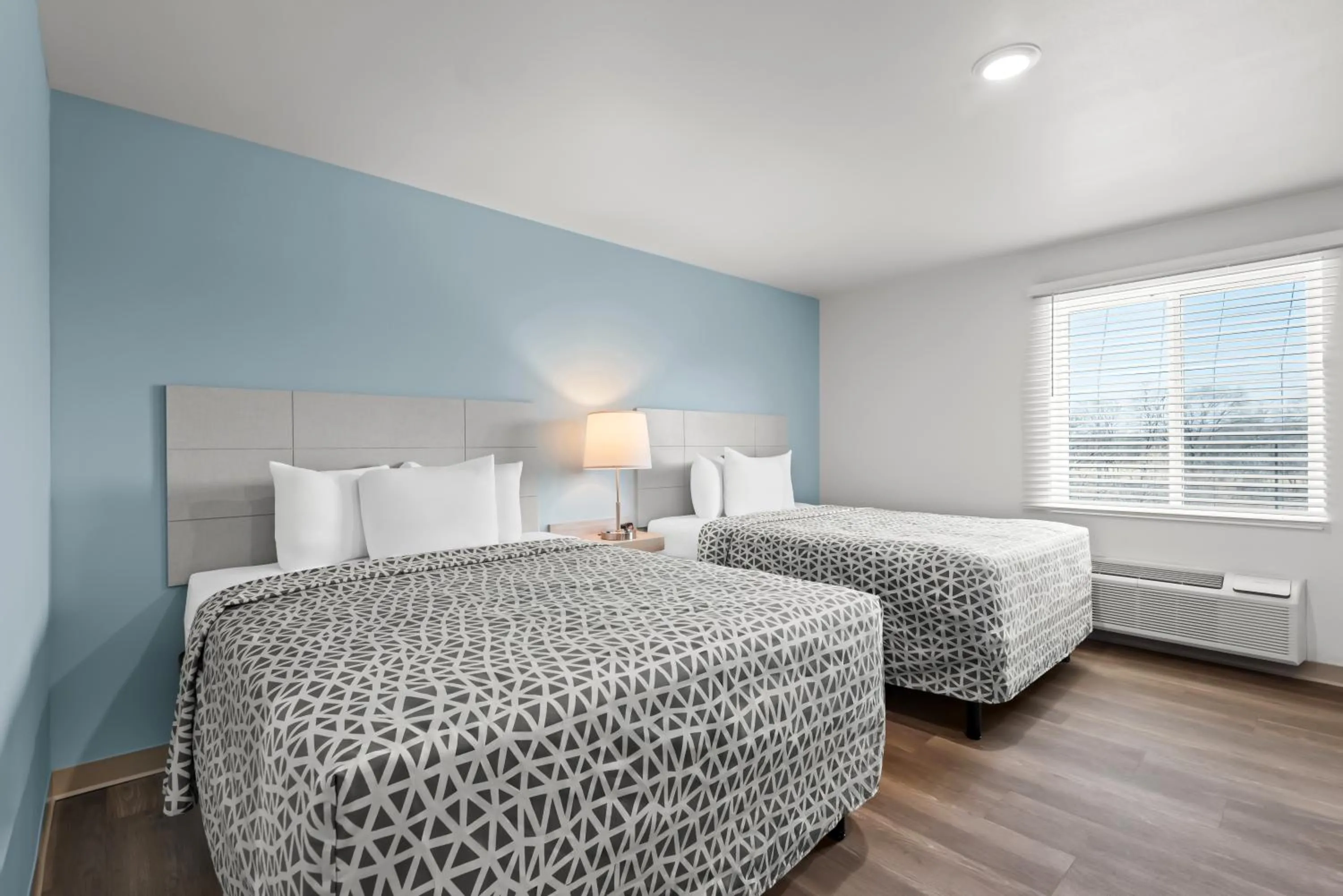 Bed in WoodSpring Suites Coralville Iowa City