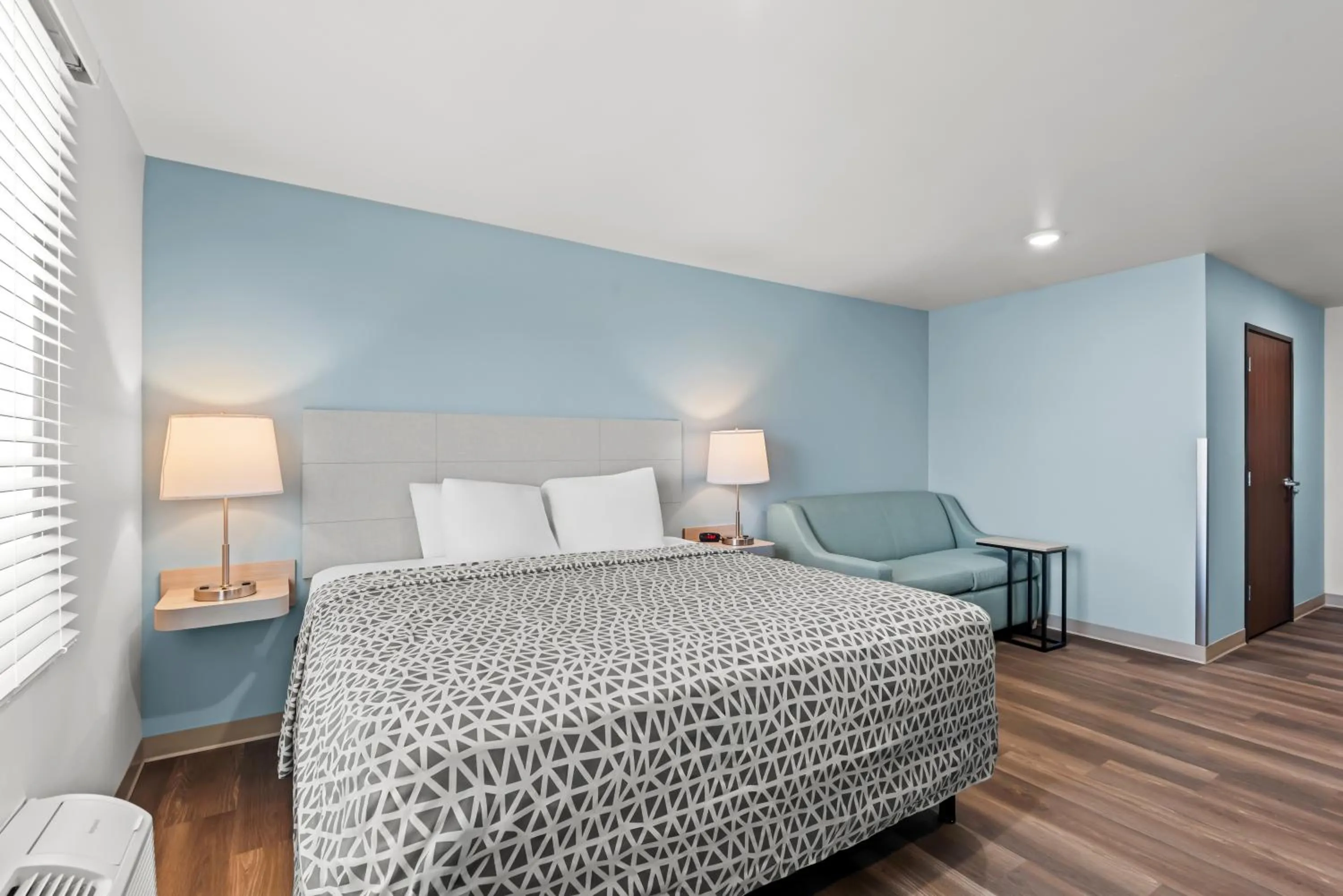 Bed in WoodSpring Suites Coralville Iowa City