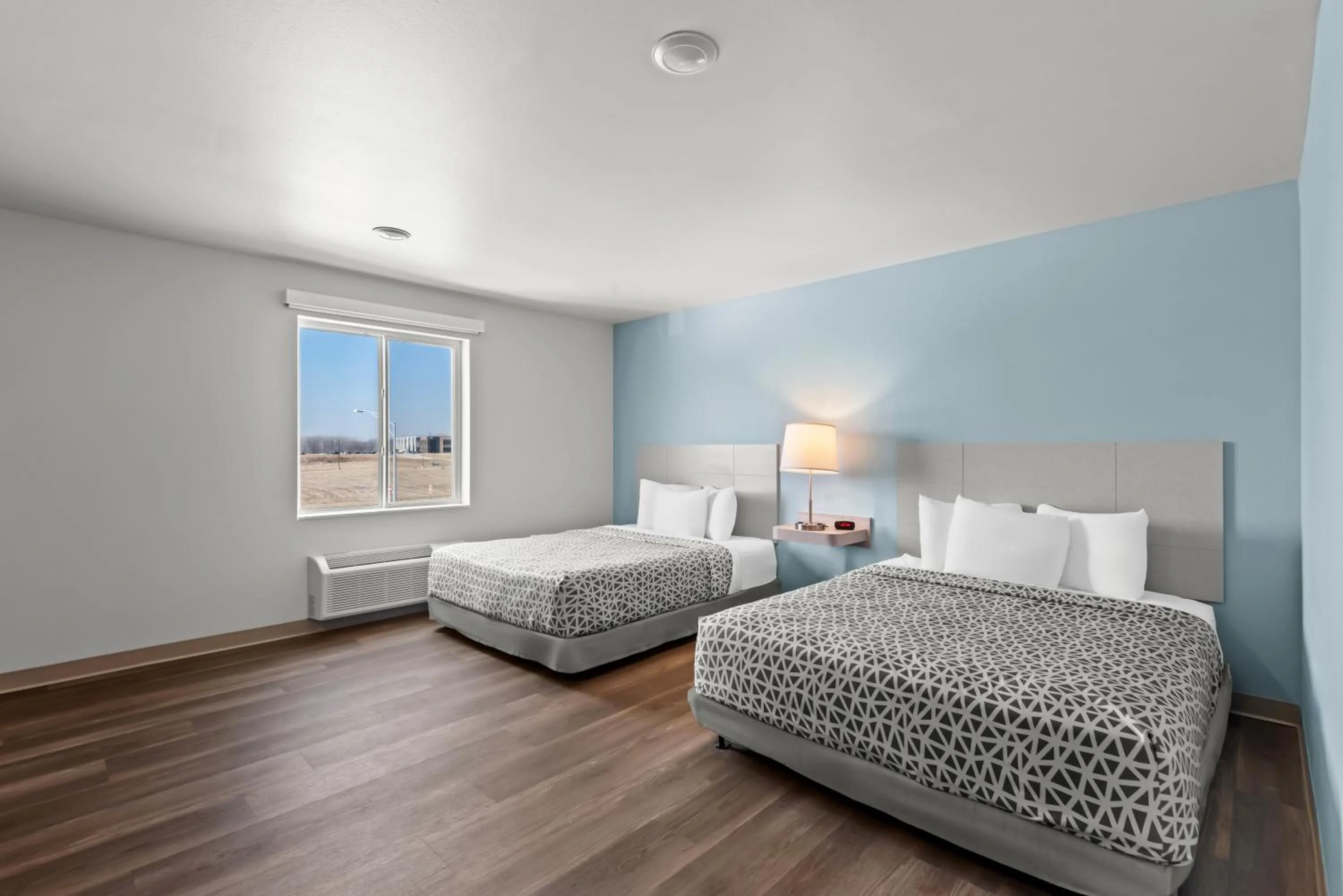 Bed in WoodSpring Suites Coralville Iowa City