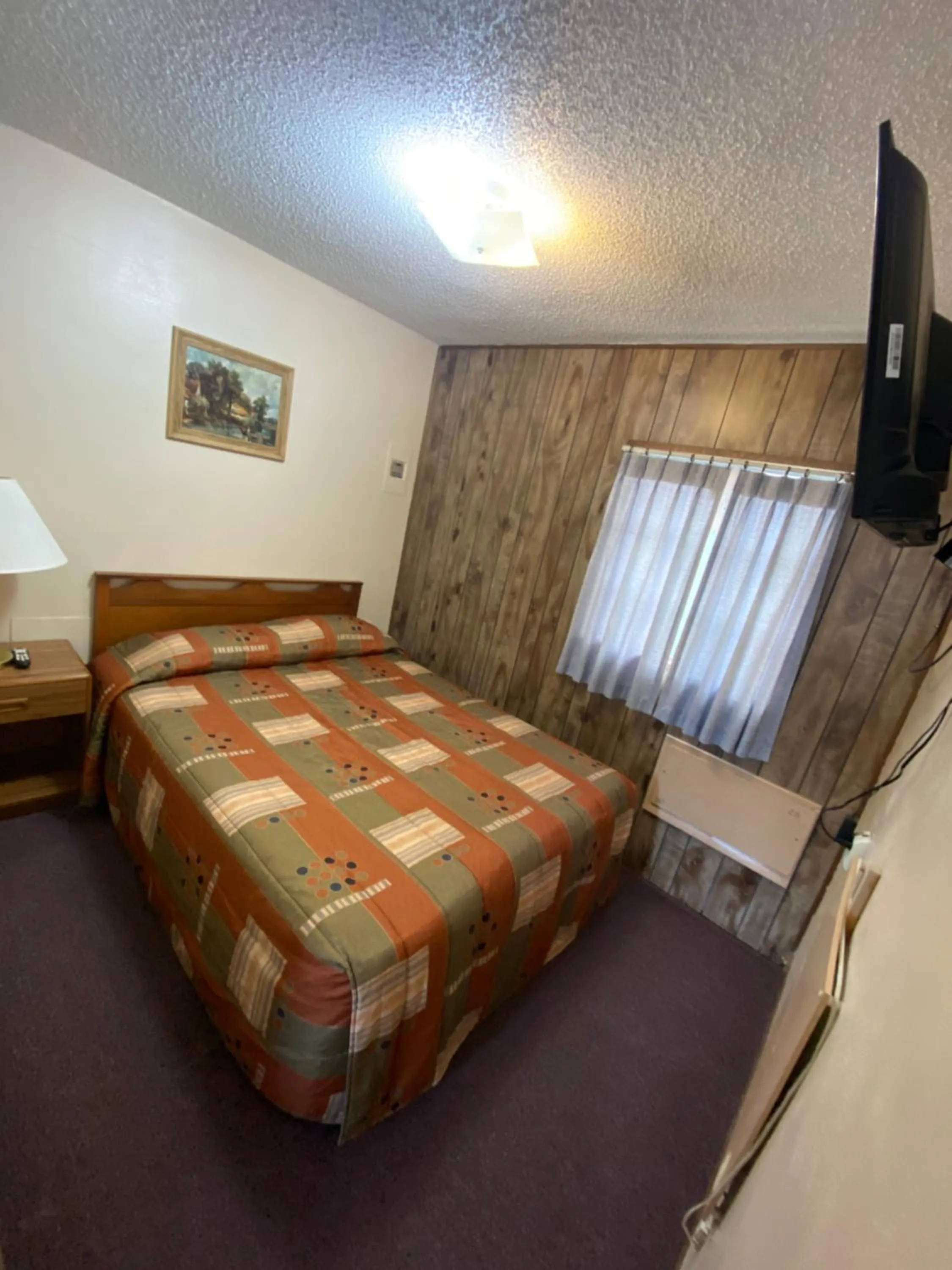 Bed in Rainbow Motel