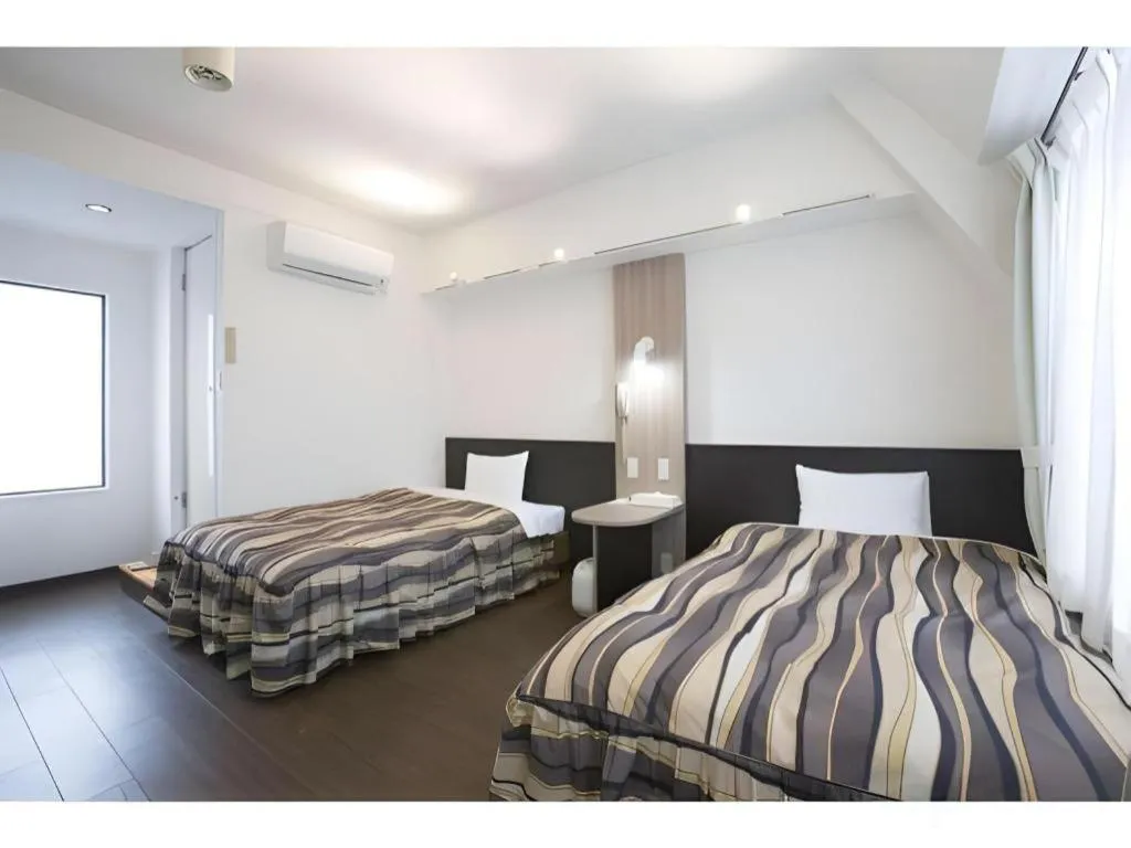 Bed in Hotel Tetora Tsurumi