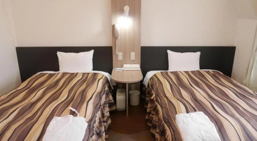 Bed in Hotel Tetora Tsurumi