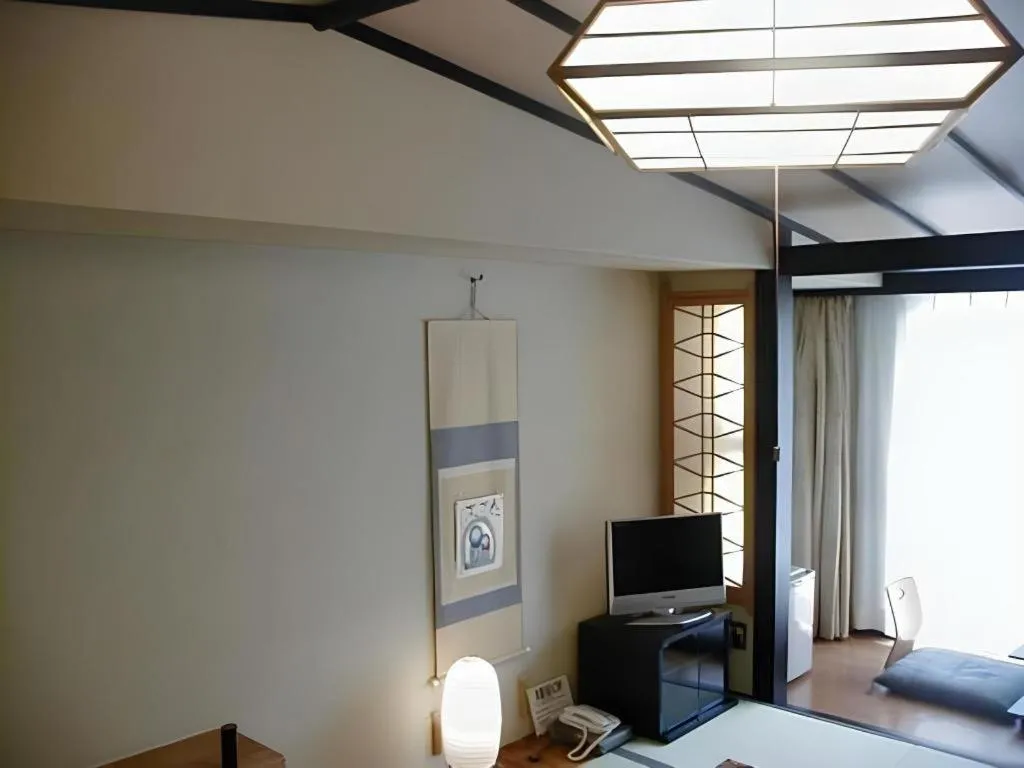 Bed in Hotel Myoken Tanaka Kaikan