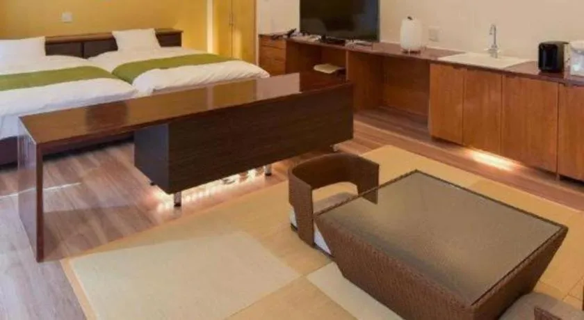 Bed in Hotel Myoken Tanaka Kaikan