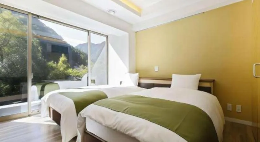 Bed in Hotel Myoken Tanaka Kaikan