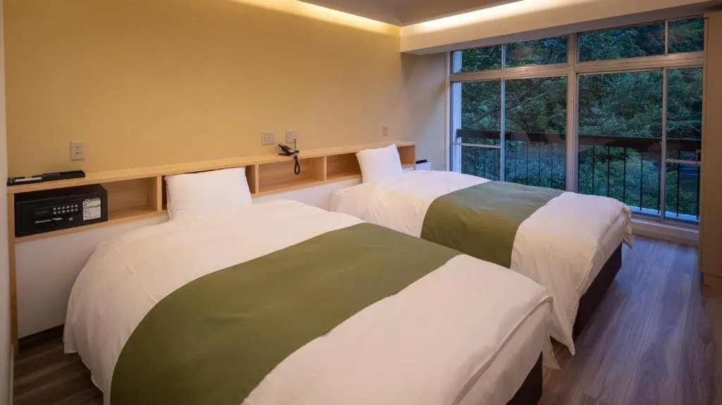 Bed in Hotel Myoken Tanaka Kaikan