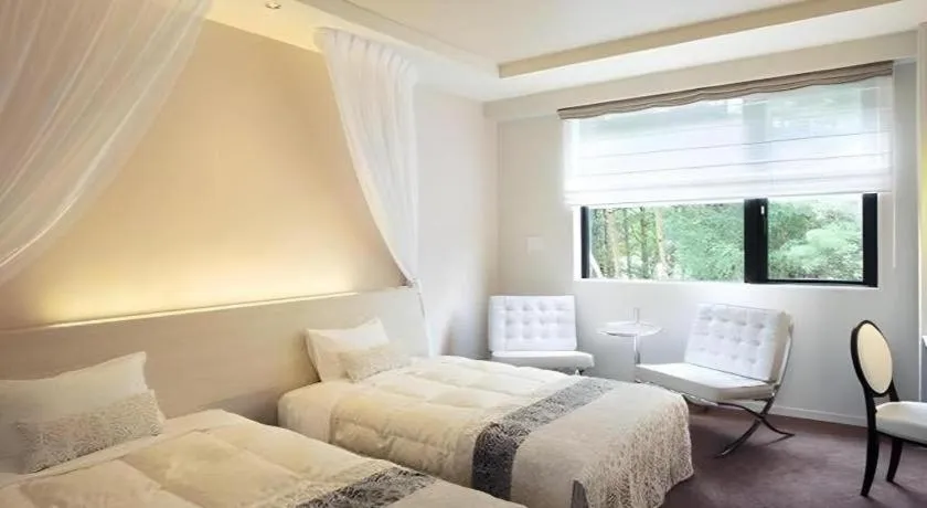 Bed in Sakuraan Kawaguchiko Hotel